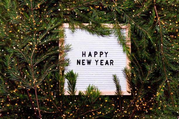 istock Letter board new year and christmas concept. Top horizontal view copyspace christmas decorations and fur tree. 1283690384