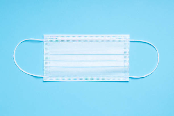 istock Medical mask on blue background 1283692057
