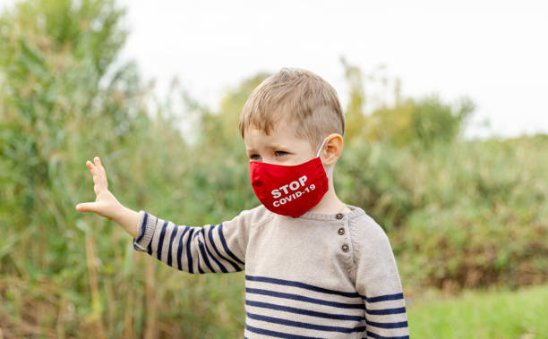 istock Beautiful child in a protective mask. Social distancing, coronavirus 1283692068