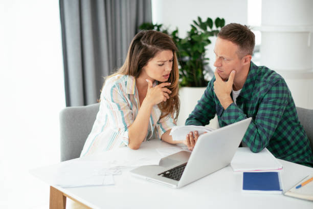 istock Husband and wife preparing bills to pay. 1283692243
