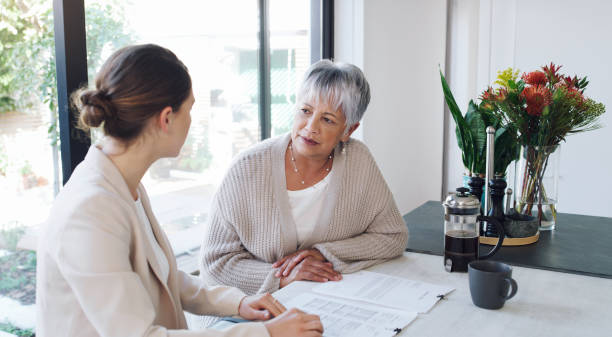 Financial advice like hers is priceless Shot of a senior woman meeting with a consultant to discuss paperwork at home will legal document stock pictures, royalty-free photos & images