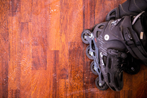 istock Plastic black rollers are on the wooden floor. The rollers have not been used for a long time and a layer of dust is visible on them. 1283693899