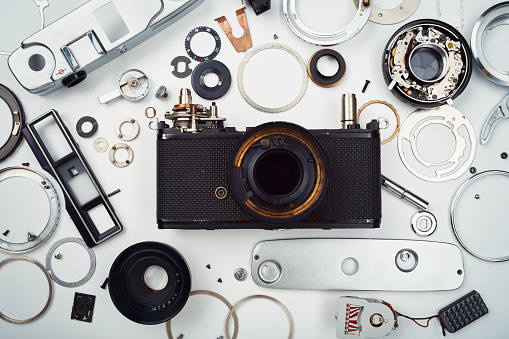 Flat lay top view of parts and components of a disassembled vintage film camera