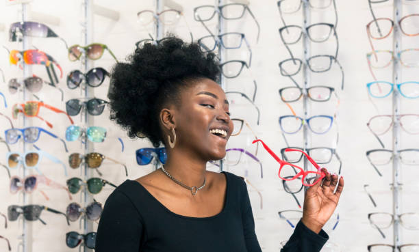 istock Young customer choosing eyeglasses in store 1283694419