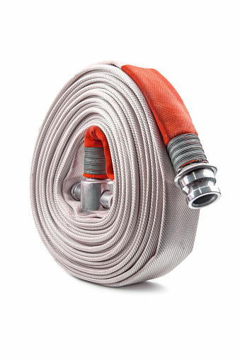 Red fire hose coil isolated on the white background.