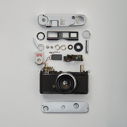 Flat lay top view of parts and components of a disassembled vintage film camera