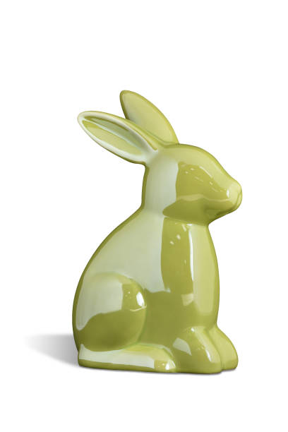 Easter bunny is of light green ceramic on white isolated background