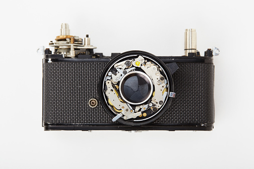 Flat lay top view of parts and components of a disassembled vintage film camera
