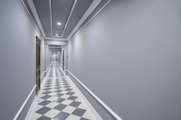 istock Empty long gray corridor in hotel with closed doors 1283696158