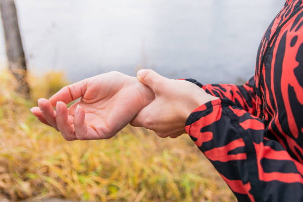 istock A woman counts the pulse on her right hand after a run. Close-up. 1283696549