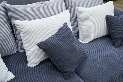 Soft pillows and a sofa made of corduroy fabric. High quality photo