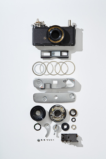 Flat lay top view of parts and components of a disassembled vintage film camera