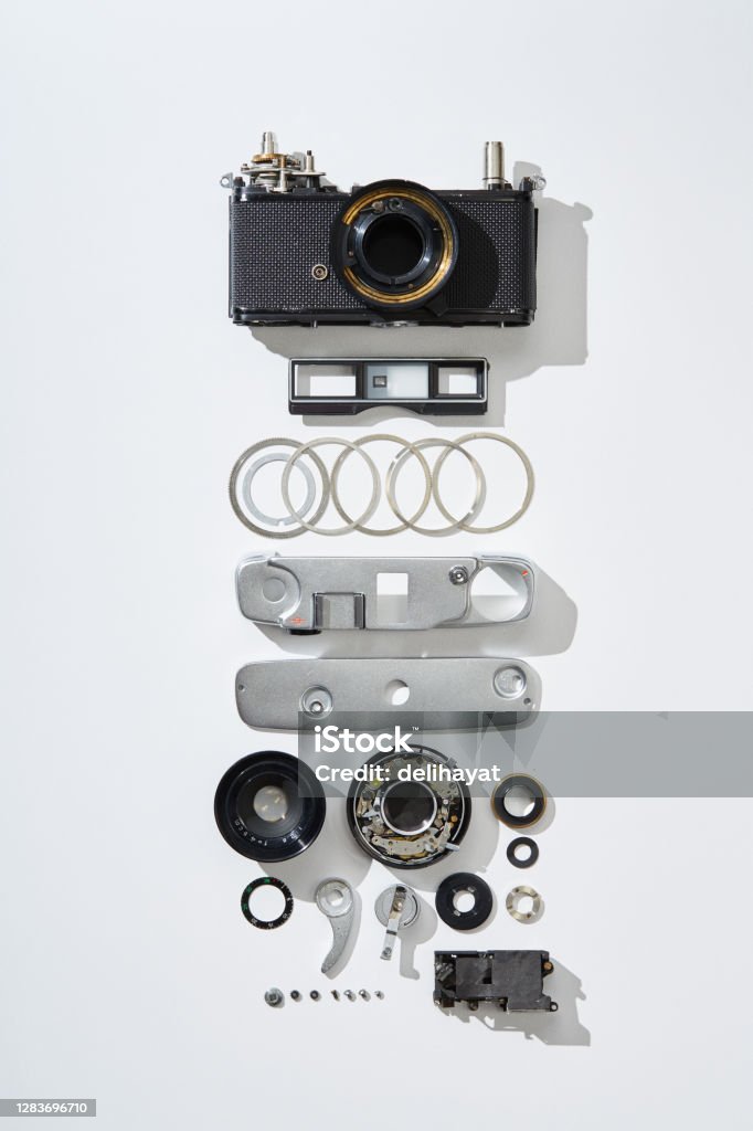 Flat lay top view of parts and components of a disassembled vintage film camera Disassembling Stock Photo