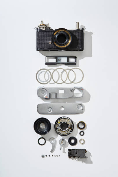 Flat lay top view of parts and components of a disassembled vintage film camera Flat lay top view of parts and components of a disassembled vintage film camera disassembling stock pictures, royalty-free photos & images