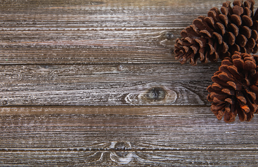 grey brown wooden space with pine cones as decoration