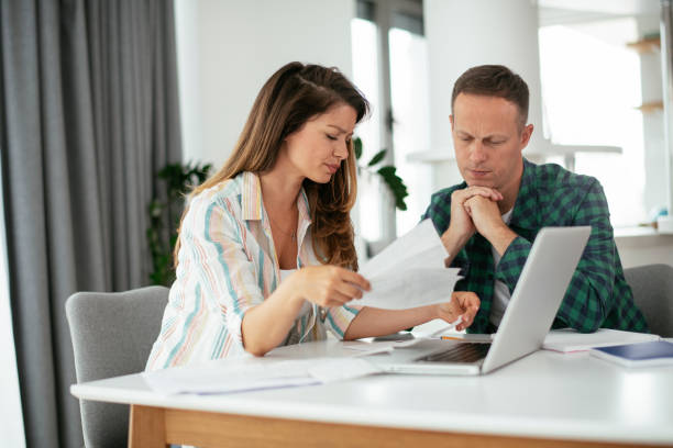 istock Husband and wife preparing bills to pay. 1283697704