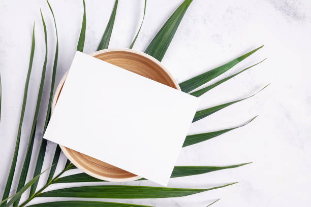 istock Paper on bamboo a bowl with palm leaf, top view 1283699074