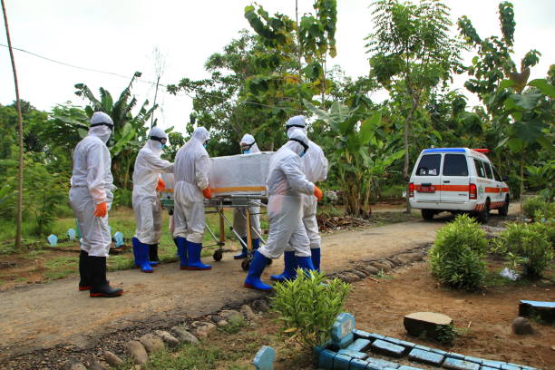 funeral for covid 19 patients, with strict health protocols funeral for covid 19 patients, with strict health protocols by officers with personal protective equipment at a public cemetery, Pekalongan, 3 November, 2020 coffin crematorium stock pictures, royalty-free photos & images