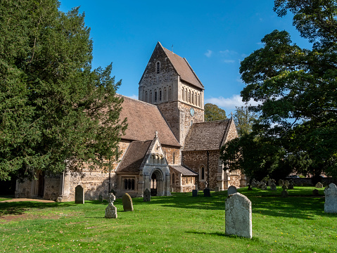 The exterior of St Lawrence church in Castle Rising, Norfolk, Eastern England. St Lawrence church is a very heavily restored Norman church containing a genuine 12th century font. Most of the restoration, both inside and outside, was undertaken during the 19th century.