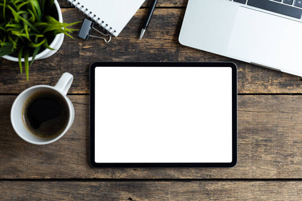 istock Mockup image tablet with blank white screen on wooden table 1283704902
