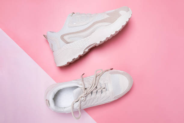 istock Beige women's sneakers on pink background. 1283705622