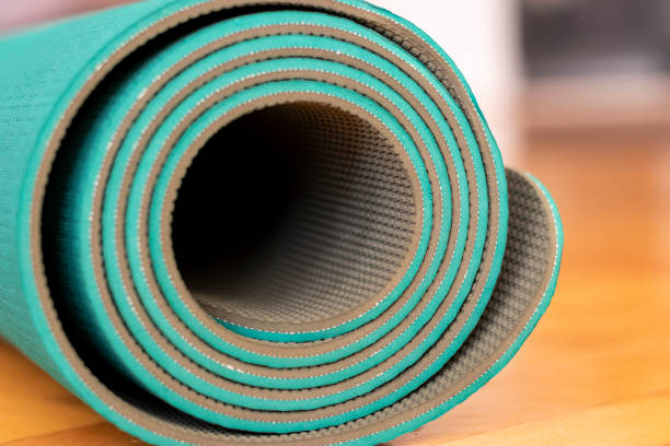istock Yoga mat rolled up lying down on the parquet floor 1283705823