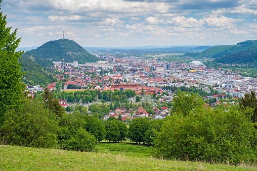 Summer city viewed from the green hill, aerial view of Piatra Neamt city in Romania