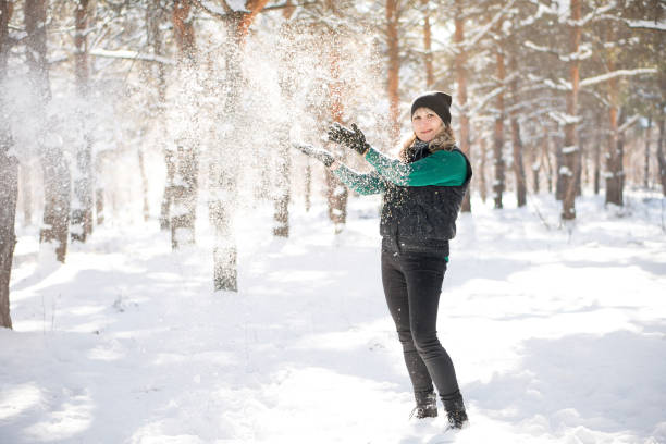 istock Woman walks in snowy forest. 1283707799