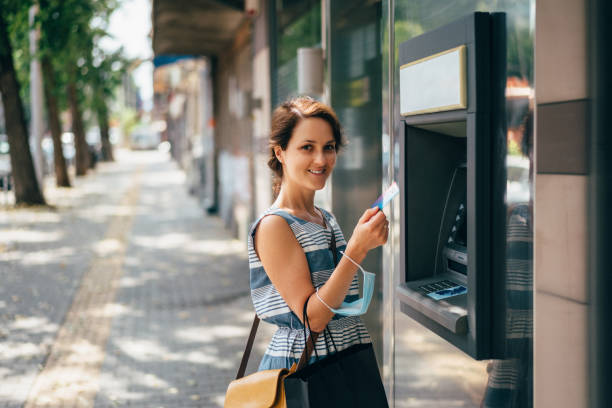 istock Woman using credit card at the ATM 1283708744