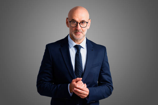 istock Confident businessman portrait at isolated grey background 1283710619