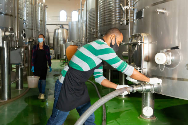 istock Male worker in mask working at winery 1283711367