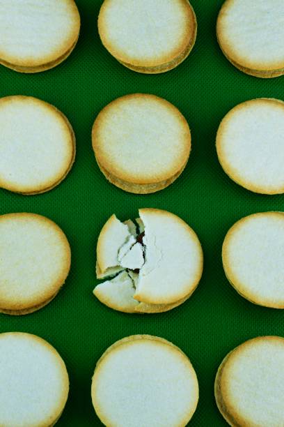 istock Sweet stuffed biscuit snack - green background. 1283711420