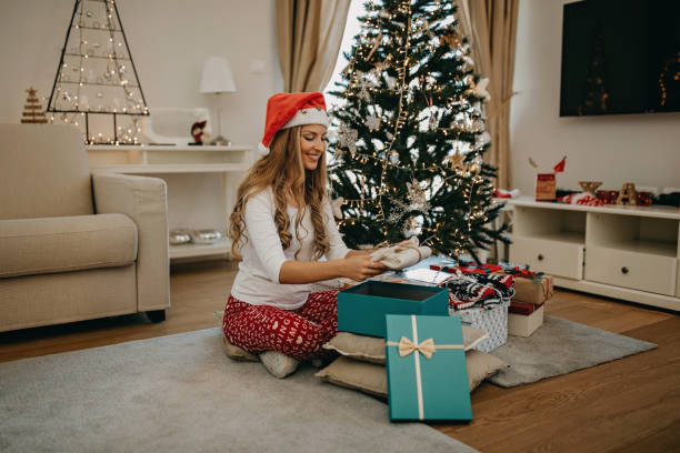 istock Young woman packing presents for Christmas 1283711581