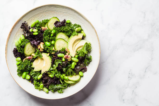 green and purple kale salad with edamame beans, avocado and cucumber, top view. healthy vegan food concept. - edamame imagens e fotografias de stock