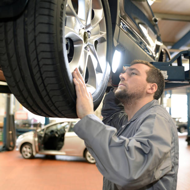 istock mechanic in a workshop checks and inspects a vehicle for defects 1283713462