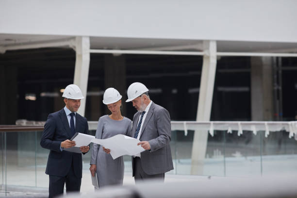 istock Group of Business People Touring Construction Site 1283713684