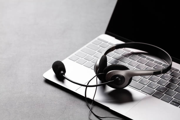 istock Office desk with headset and laptop 1283714122