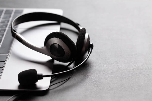 istock Office desk with headset and laptop 1283714149