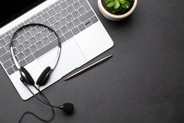 istock Office desk with headset and laptop 1283714669