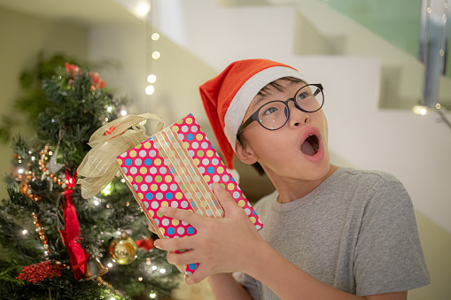 Asian Chinese teenage boy excited getting Christmas present