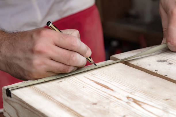 istock Male carpenter working with wood material in a garage. 1283715082