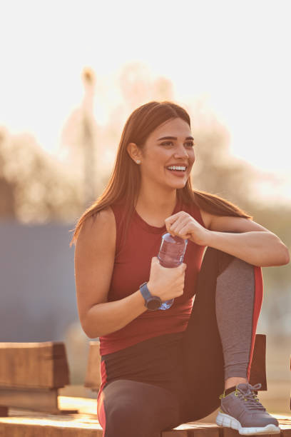 istock Modern young woman making pause after jogging / exercise. 1283715112