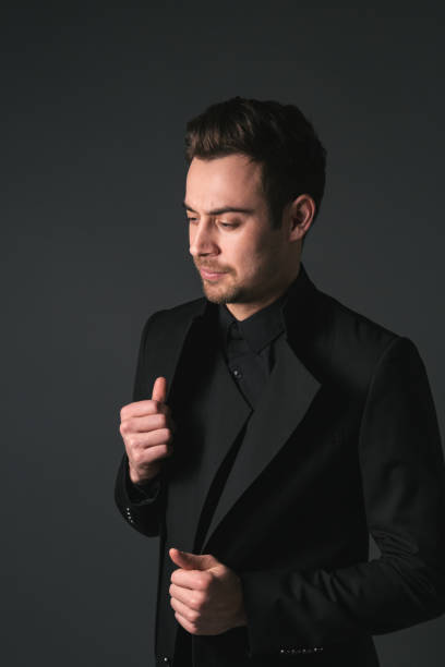 istock Studio portrait of a young man in a black blazer against plain studio background 1283716278