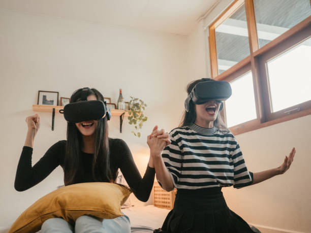istock Young friends using VR together at home. 1283716454