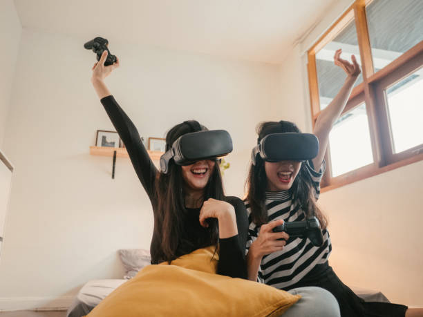 istock Asian couple lesbians playing a VR device at home. 1283716513