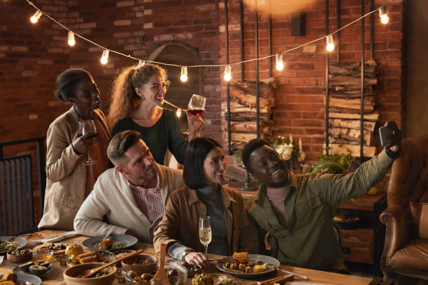 istock Friends Taking Selfie Photo at Dinner Party 1283716634