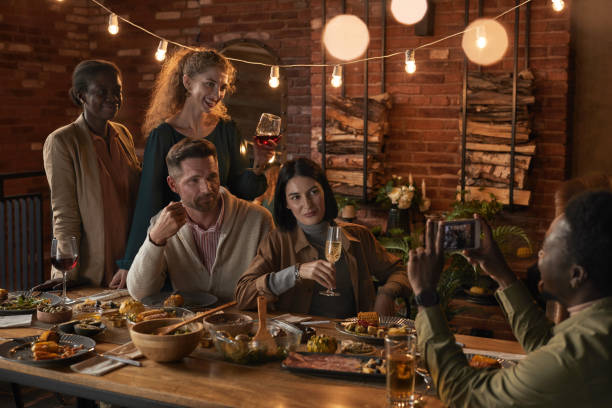 istock Friends Taking Photo at Dinner Party 1283716638