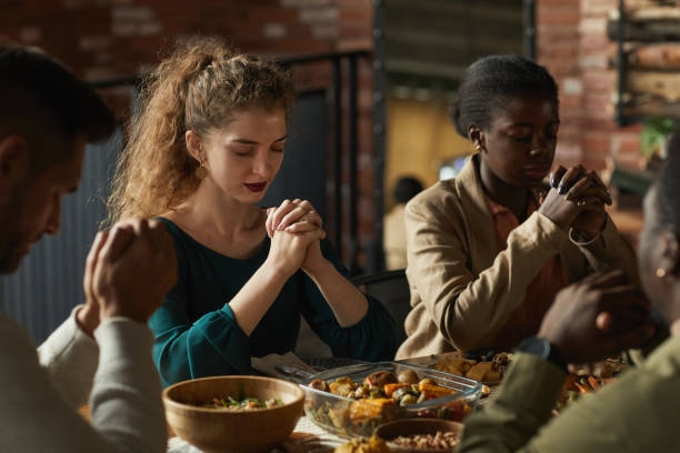 istock People Praying at Thanksgiving Dinner 1283716716