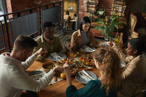 istock Group of People Praying at Dinner 1283716723