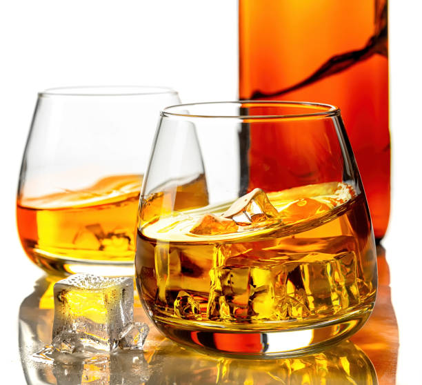 istock Glasses of whisky and ice on a white background 1283719596